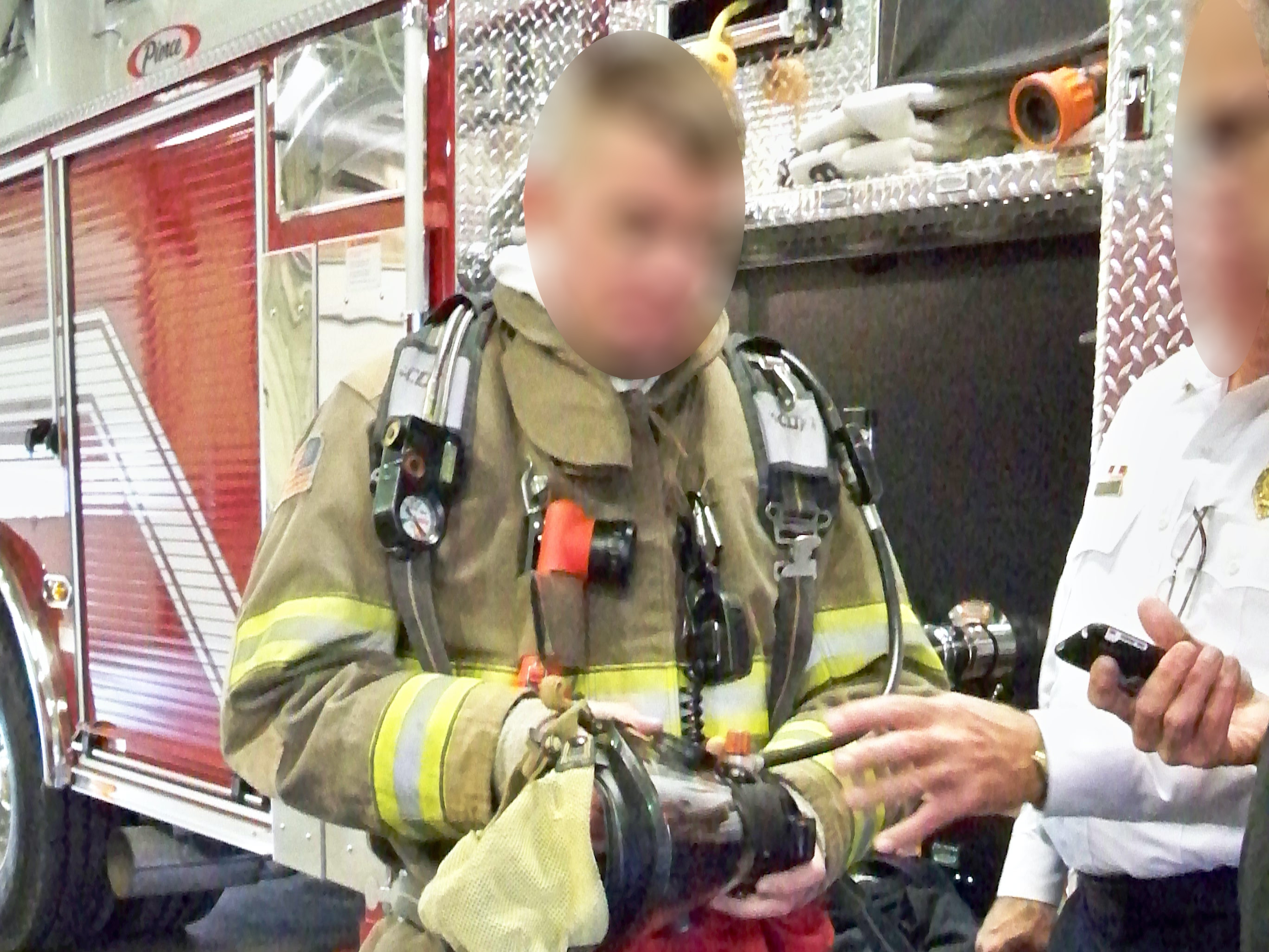 Firefighter demonstrating standard personal protective equipment (PPE).